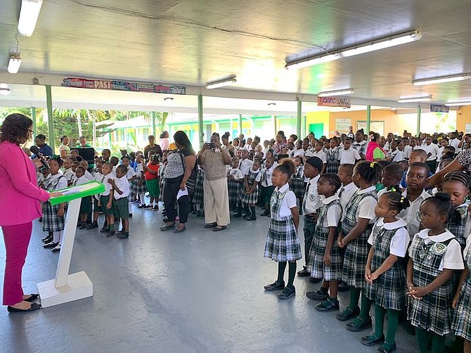During assembly, Mrs. Avinel Newball-Smith, Principal, Cleveland Eneas Primary School, reminds students that there will be  activities on campus, throughout the day, to celebrate literacy, including Reading in the Garden, Sip and Read, and Drop Everything and Read.