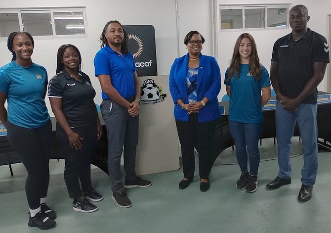 Player Rachel Rolle, coach Ricqea Bain, Minister of Sports official Adam Miller, BFA president Anya James, player Melina McClure and BFA Technical Director Bruce Swan pose from left to right.