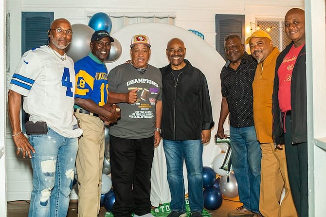 The late Minister Obie Wilchcombe shares a moment with Burkett Turnquest and friends at his recent birthday.