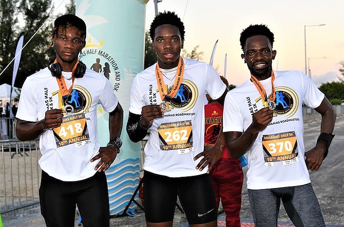 THE top three male winners in the 2022 Bahamas Half Marathon with their medals.