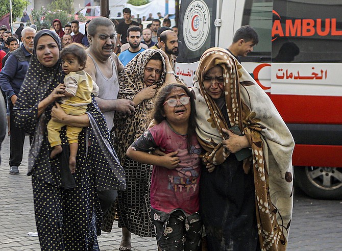 Injured Palestinians arrive at al-Shifa Hospital following Israeli airstrikes on Gaza City, central Gaza Strip, yesterday. 
Photo: Abed Khaled/AP