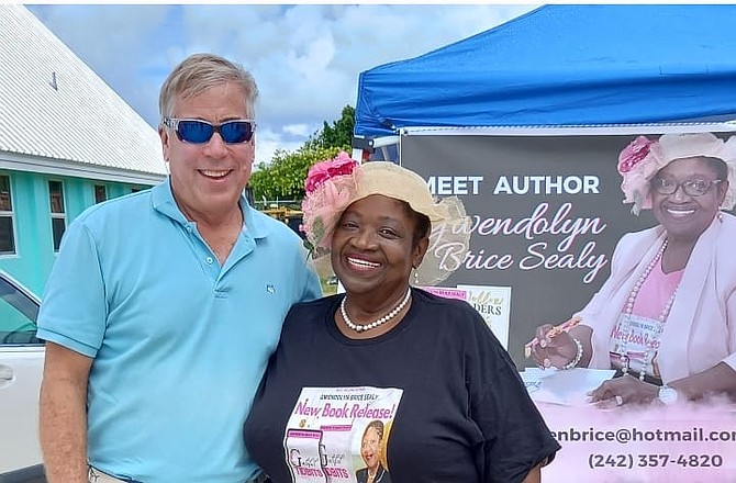 Deacon Jeff Leslie of Palm Beach Lakes Church of Christ stands next to Nurse Gwendolyn Sealy at her book signing in Abaco.