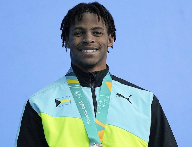 MEDAL GLORY: Lamar Taylor, of The Bahamas, poses with the bronze medal on the podium of men’s 50-metres freestyle at the Pan American Games in Santiago, Chile, October 24, 2023. 
(AP Photo/Silvia Izquierdo)