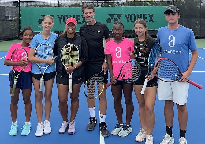 YOUNG, aspiring tennis players are shown with coaches Patrick Mouratoglou and Richele LeSaldo.