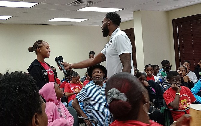 Leevan Sands interacts with one of the athletes during the Red-Line Athletics’ seminar on Saturday.