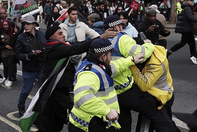 Police Officers clash with rival supporters as protesters walk past the Cenotaph on Whitehall during a pro-Palestine march organised by Palestine Solidarity Campaign in central London, on October 28, 2023. 
Photo: Jordan Pettitt/AP