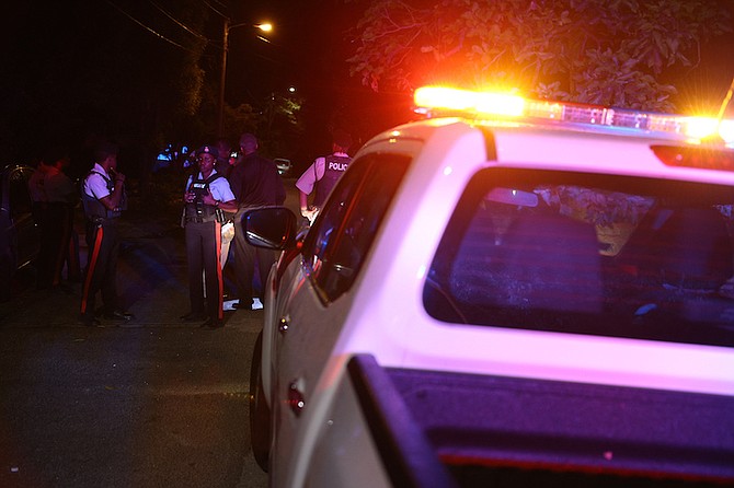 Police at the scene in the Fox Hill area last night. Photos: Dante Carrer