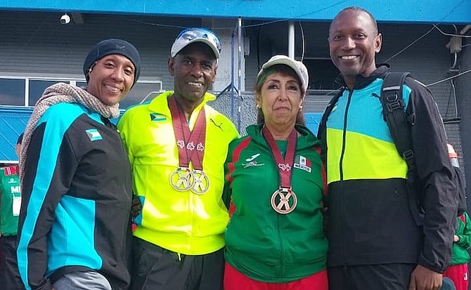 Bahamians Natasha Brown, Mike Armbrister and Nick Dean pose above with one of their Mexican friends at the NCCMA Outdoor Athletics Championships in Juarez City, Mexico.