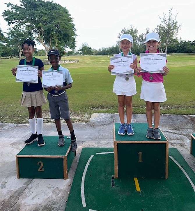 ON THE PODIUM: Samantha Mahelis and Liv Ward (right) finished first and the duo of Payton
McKenzie and Tyhler Rolle (left) claimed second at the Front 9 Golf Tournament series Sunday.