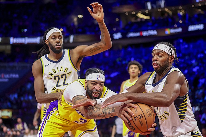 LOS Angeles Lakers forward Anthony Davis (3) grabs a rebound next to Indiana Pacers forward
Isaiah Jackson (22) and guard Buddy Hield (7) during the second half of the championship game in
the NBA basketball In-Season Tournament on Saturday in Las Vegas.
(AP Photo/Ian Maule)
