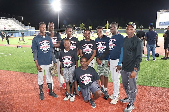 COACH MARIO FORD, far right, with players from his baseball camp.