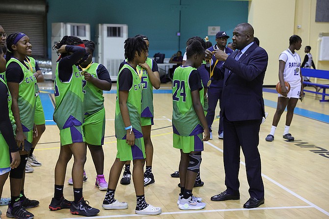 HEART OF A CHAMPION: Minister of Youth, Sports and Culture Mario Bowleg presents medals to the CV Bethel Stingrays senior girls, who took home the championship title yesterday. Six teams hoisted championship trophies at the conclusion of the 35th Father Marcian Peters Invitational Basketball Tournament at the Kendal GL Isaacs Gymnasium. 
Photo: Dante Carrer