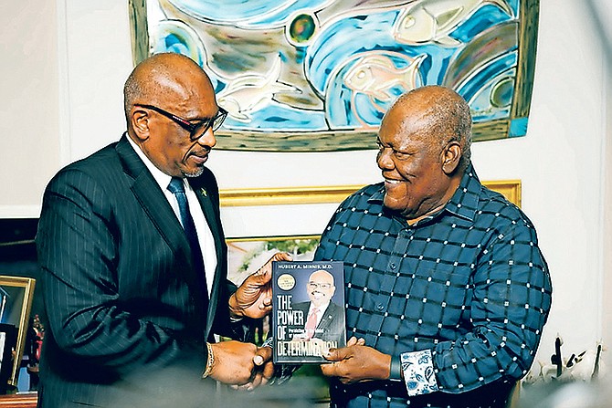 FORMER Prime Minister Dr Hubert Minnis presented a copy of his new book, “The Power of Determination”, to Hubert Ingraham yesterday.
Photo: Moise Amisial