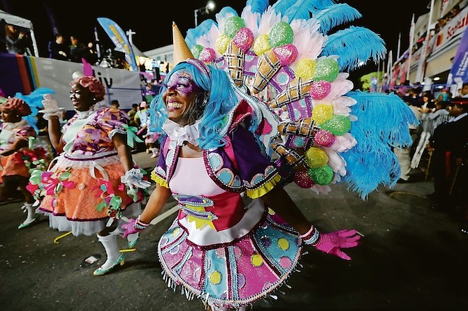 The Boxing Day Junkanoo parade began last night after a 24 hour delay, Junkanoo group Genesis is seen here on their way through Rawson Square.
 Photo: Dante Carrer