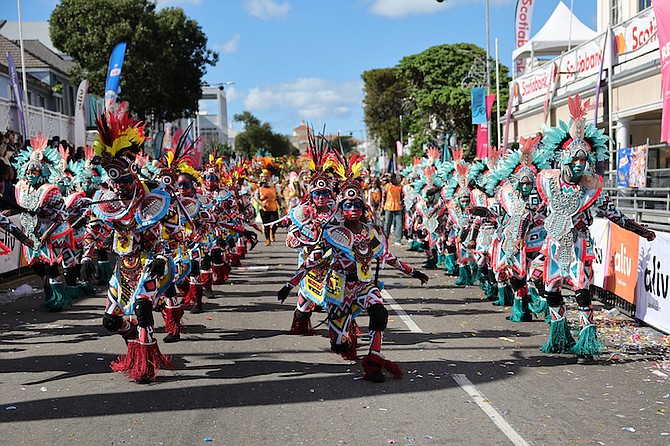 Members of Shell Saxon Superstars rushing during the New Year’s Day Junkanoo Parade. The Saxons placed first in the A division. 
Photo: Dante Carrer