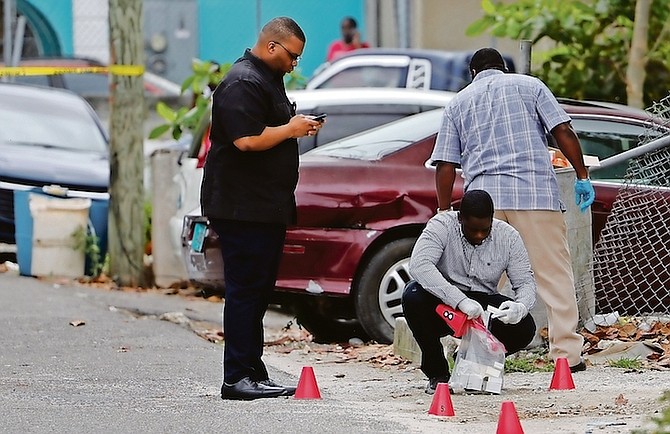 Police at the scene of the shooting on Lily of the Valley corner on Thursday.
Photo: Dante Carrer