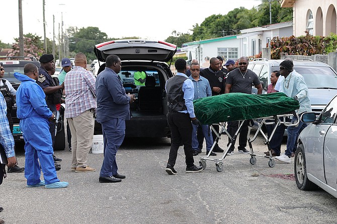 THE BODY of Eric Morley being taken from the scene of the double shooting in the Pinewood area on Sunday afternoon.
Photo: Dante Carrer