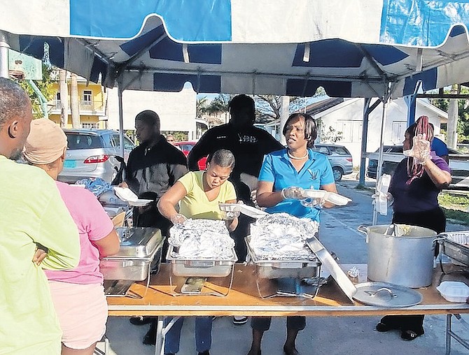 Free breakfasts being handed out yesterday in Nassau Village. 
Photos: Moise Amisial