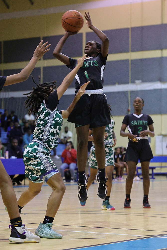 BALL IN PLAY: St John’s Giants junior girls defeated the St Augustine’s College (SAC) Big Red Machine yesterday in Game 1 of the Bahamas Association of Independent Secondary Schools’ best-of-three championship series at Kendal Isaacs Gymnasium.