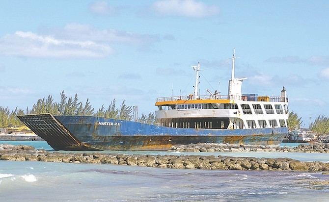 A LARGE unmanned cargo vessel broke loose from Arawak Cay and ran aground off Saunders Beach yesterday. 
Photo: Dante Carrer