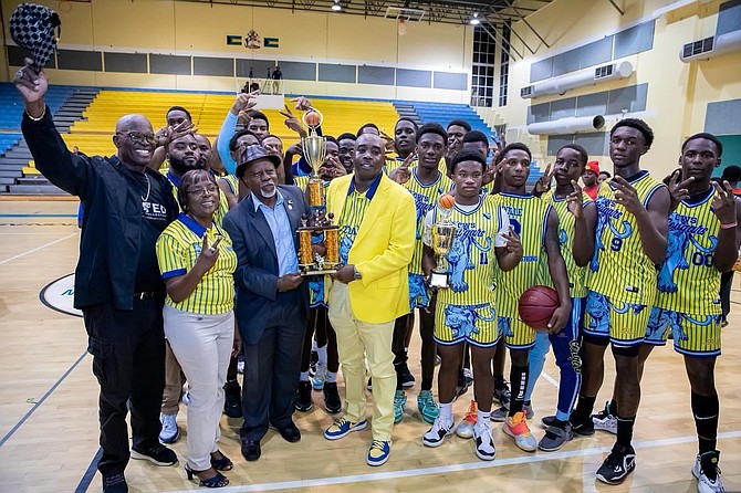 BAISS president Rev. Perry Cunningham presents coach Dario Burrows and his CW Saunders Cougars senior boys with their championship trophy. Rev. Dr. Philip McPhee and principal Annabel Thompson join in.