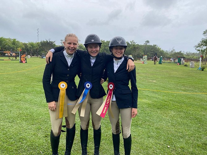 SIENNA Jones (centre) placed 1st overall in the CEA Mini Jumping Challenge Height Class B, besting riders from Ber- muda, Barbados and the Cayman Islands. Emma Johnston (right) and Sennen Fitzmaurice (left) placed 3rd and 5th overall respectively.