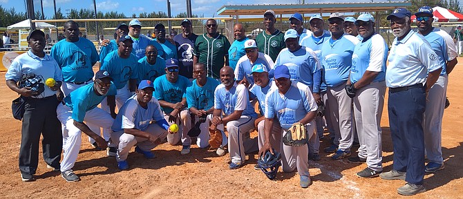 REV. Dr. William Thompson is flanked by players and officials of the Masters Softball League game beween the Divers and the Scorpions at the Baillou Hills Sporting Complex.