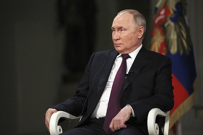 In this photo released by Sputnik news agency on Friday, Russian President Vladimir Putin attends an interview with former Fox News host Tucker Carlson at the Kremlin in Moscow, Russia, on February 6, 2024. 
Photo: Gavriil Grigorov, Sputnik, Kremlin Pool Photo/AP
