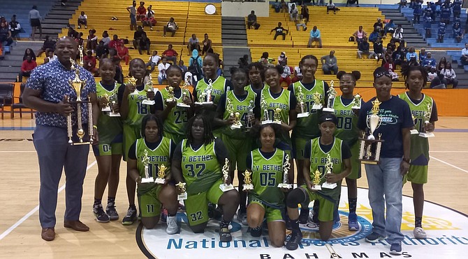 TIME TO CELEBRATE: The CV Bethel Stingrays (top) and CI Gibson Rattlers proudly display the senior girls and boys trophies for the Government Secondary Schools Sports Association (GSSSA) basketball championships last night. Photos: Tenajh Sweeting/Tribune Staff