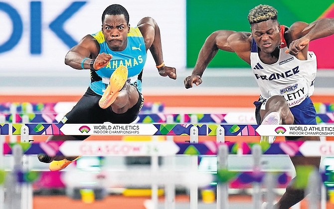 KEN MULLINGS, of The Bahamas, and Makenson Gletty, of France, compete in the Heptathlon 60 metres hurdles on Sunday.
(AP Photo/Petr David Josek)
