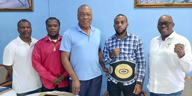 Andre Seymour, Valentino Knowles, Wellington Miller and Vincent Strachan surrounds NBA welterweight champion Rashield Williams.