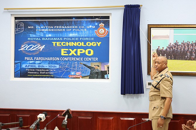 POLICE Commissioner Clayton Fernander unveils the banner for the Royal Bahamas Police Force (RBPF) Technology Expo is displayed during a press conference at Police Headquarters yesterday.
Photo: Dante Carrer