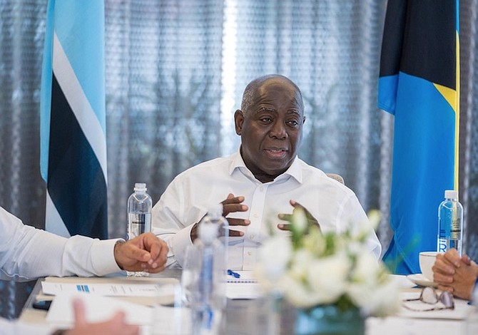 Prime Minister Philip Davis speaks with members of the Bahamian delegation during the state visit to Botswana.