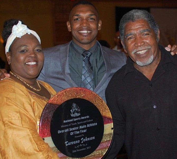 Taureano ‘Reno’ Johnson is flanked by his mother Ikenna Johnson and his late father, Erwin Johnson.