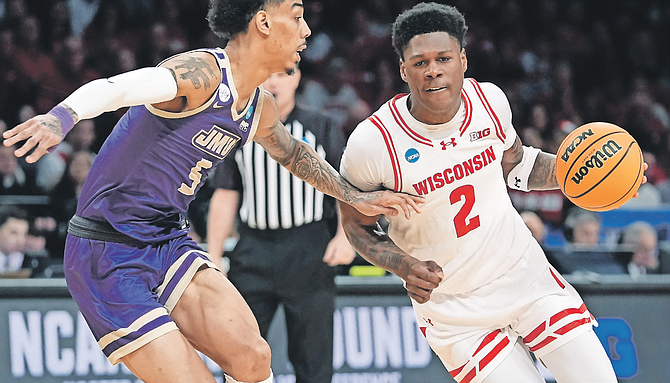 WISCONSIN guard AJ Storr (2) drives against James Madison guard Terrence Edwards Jr during a first-round college basketball game in the men’s NCAA Tournament on March 22 in New York. (AP Photo/Mary Altaffer)
