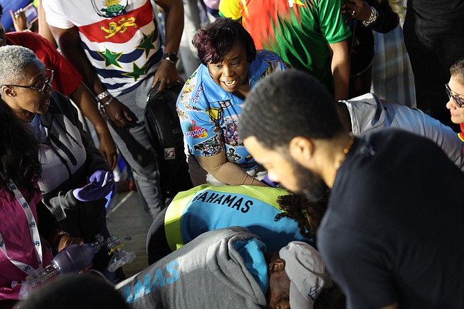 Efforts to treat a parent who collapsed at the CARIFTA aquatic championships on Saturday. 
Photo: Dante Carrer