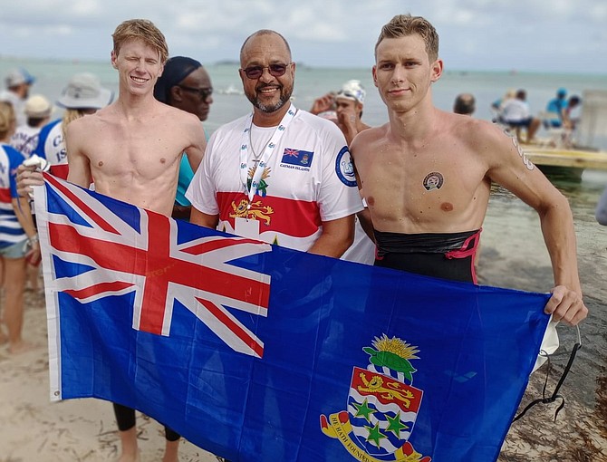 TOP 2 SPOTS: Cayman Islands’ Minister of Youth, Sports and Heritage Isaac Rankine with Connor Macdonald and Dominic Hilton after they took the top two positions in the CARIFTA Games Open Water 5K Swim at Goodman’s Bay yesterday.