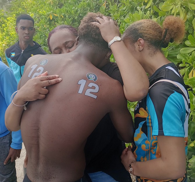 Don Saunders son, Don Jr, with sister Danielle, hugs his mom (Tiffany), an emotional moment after placing eighth in the CARIFTA 2024 open water swim.