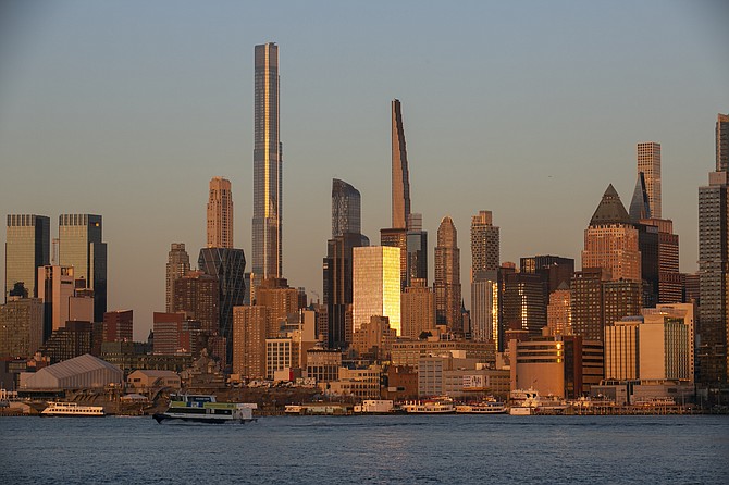 Light from the setting sun reflects off the buildings in the borough of Manhattan in New York, as seen from the Weehawken Pier in Weehawken, N.J., on Wednesday, March 22, 2023. (AP Photo/Ted Shaffrey, File)