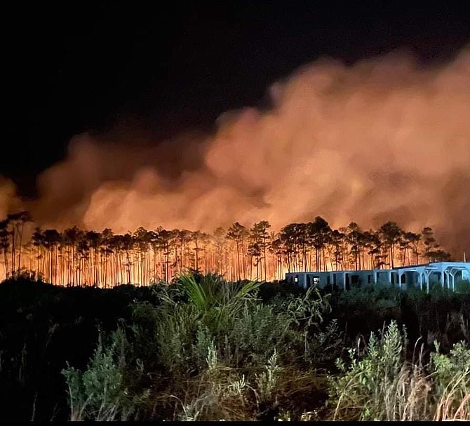 FIREFIGHTERS in North Andros are keeping a close watch on a large forest fire that erupted on the island last week, producing large plumes of thick, black smoke over surrounding communities.