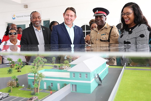 North Abaco MP Kirk Cornish, Minister for Central and South Abaco John Pinder II and Chief Superintendent Will Hart during a ceremony to unveil the model of a new police headquarters in Abaco yesterday.  Photos: Dante Carrer