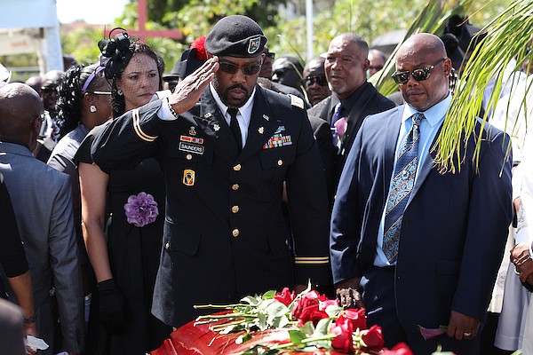 Dion Saunders, twin brother of Former MP Donald “Don” Saunders, offers a final salute during the internment of the late MP at St Agnes Cemetery on April 19, 2024. Photo: Dante Carrer