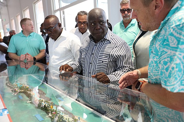 DEPUTY Prime Minister and Minister of Tourism, Investment and Aviation Chester Cooper, Prime Minister Philip “Brave” Davis and other officials view a model of the proposed Royal Beach Club during a reception at the Nassau Cruise Port following a groundbreaking ceremony on western Paradise Island yesterday. Photos: Dante Carrer