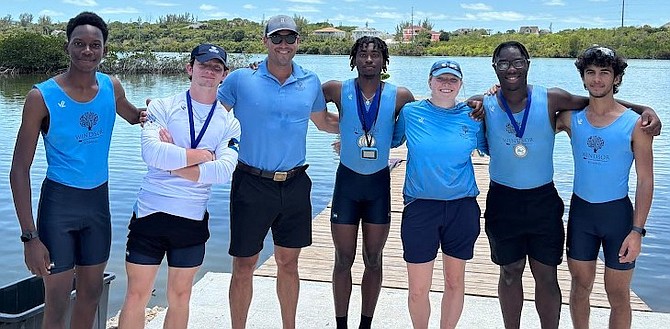 Isaiah Ellis, center, is flanked by coach Rob Gibson and members of Windsor School boy's rowing team.