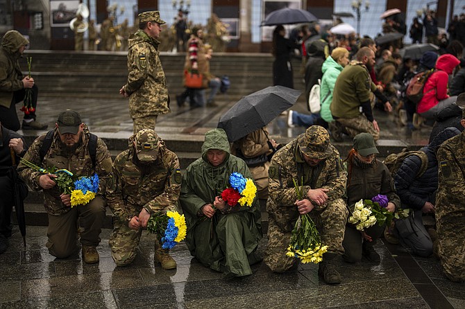 Family, friends and army comrades gather to pay respect to Ukrainian army paramedic Nazarii Lavrovskyi, 31, killed in the war, during his funeral ceremony at Independence square in Kyiv, yesterday.Lavrovskyi, who served in the 244th battalion of the 112th Separate Territorial Defense Brigade, was killed April 18 while helping to evacuate wounded troops from the frontline in the Kharkiv area of eastern Ukraine. Photo: Francisco Seco/AP