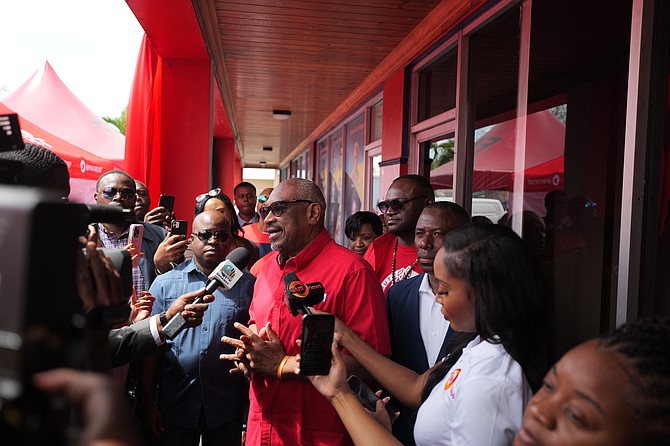 FORMER Prime Minister Hubert Minnis speaks to the press outside FNM headquarters Friday after nominating to run for the leadership of the party. Former MP Renward Wells stands to his right. Photo: Chappell Whyms Jr