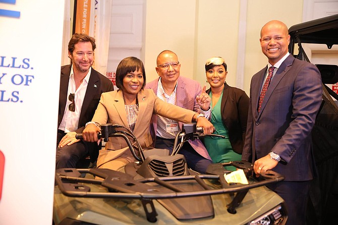 Ginger Moxey, minister for Grand Bahama, gets the feel of a new model ATV that was on display at the 2024 Freeport Business Expo. Ian Rolle, president of the Grand Bahama Port Authority, and other Executives look on.
Photo:Lisa Davis/BIS