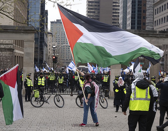 A pro-Palestinian supporter waves a flag as pro-Palestinians and pro-Israel supporters hold opposing demonstrations at the McGill University campus, in Montreal, Thursday, May 2, 2024. Photo: Ryan Remiorz/The Canadian Press via AP