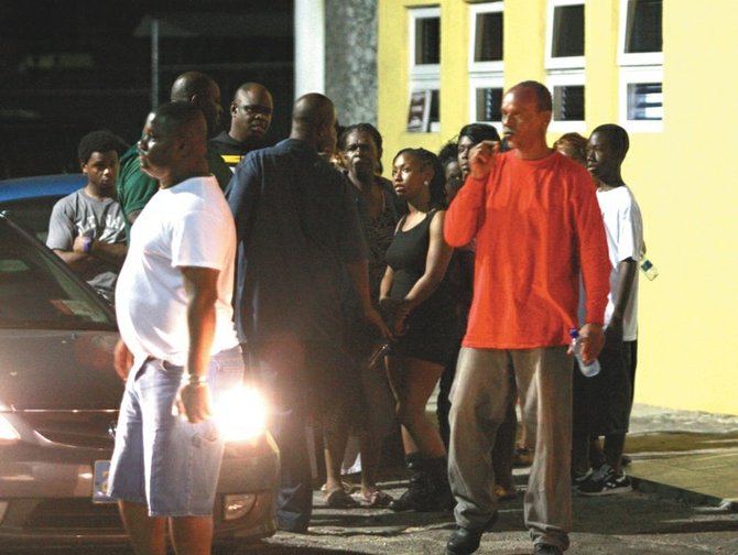 Friends and relatives wait anxiously for news outside hospital Tuesday night following the shooting.