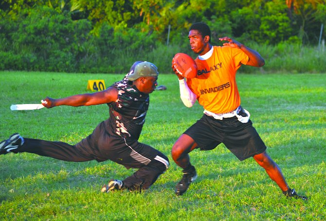 TAKING THE FLAG: In Bahamas Flag Football League week 12 action, a Go Green Predator (left) grabs the flag off a Galaxy Invader. The Predators closed the day with a 14-7 win over the Invaders. One slot remains undecided for the playoffs which begin in just under three weeks.